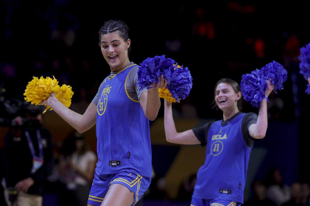 UCLA’s Lauren Betts (51) and UCLA’s Gabriela Jaquez (11) dance after an open practice at Mortgage Matchup Center in Phoenix on Saturday, April 4, 2026.
