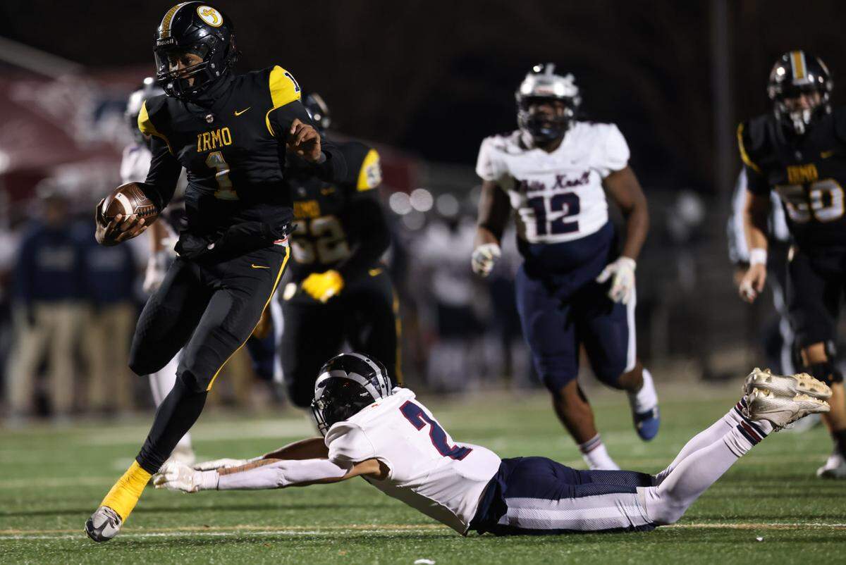 AJ Brand (1) of Irmo skirts the tackle of Devin Geronomi (2) of White Knoll and carries the ball in for a touchdown during Irmo’s game against White Knoll in their Class 5A Division II semifinal game in Irmo on Friday, December 6, 2024.