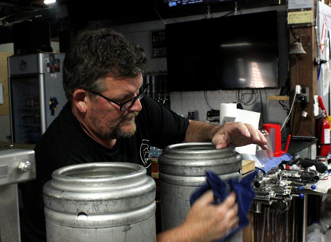 Kenny Hodge works to fill and wash kegs at Lexington’s Angry Fish Brewing Co. on May 22, 2024.
