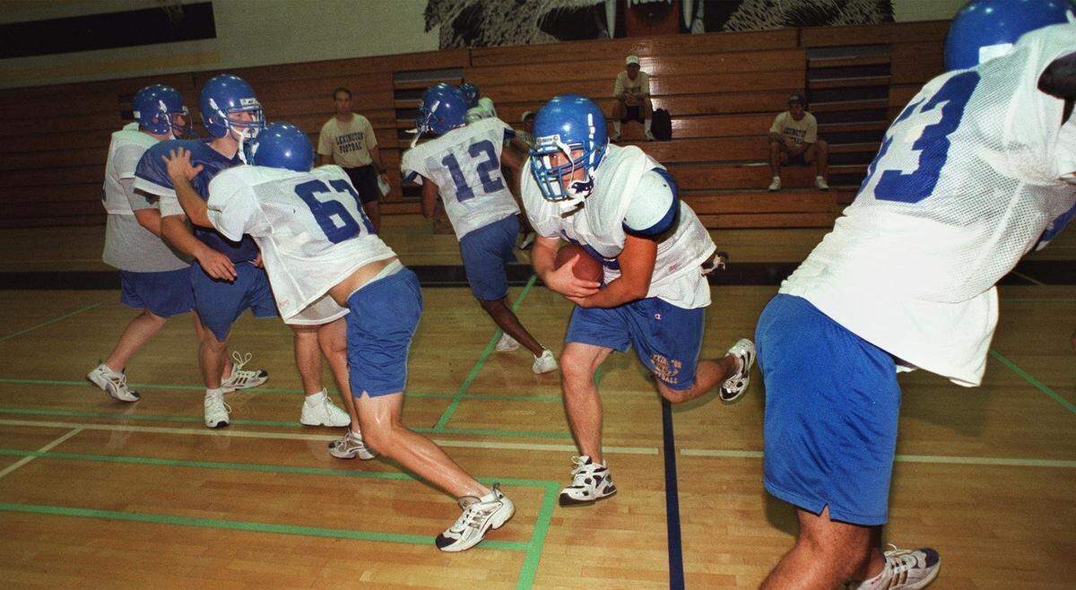 Dustin Curtis runs the ball during practice in the gym during a Lexington practice.