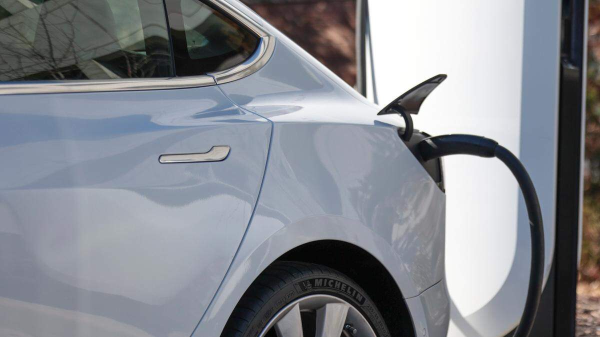 Electric vehicles park at a charging station.