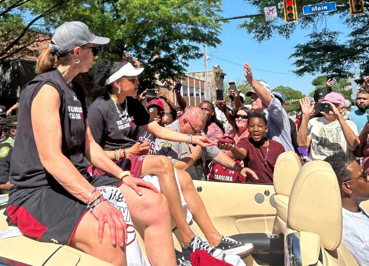 The city of Columbia holds a parade on Main Street to honor the South Carolina women’s basketball team’s 2024 national championship. Here, Dawn Staley and assistant coach Lisa Boyer ride together in a Rolls Royce on the parade route.