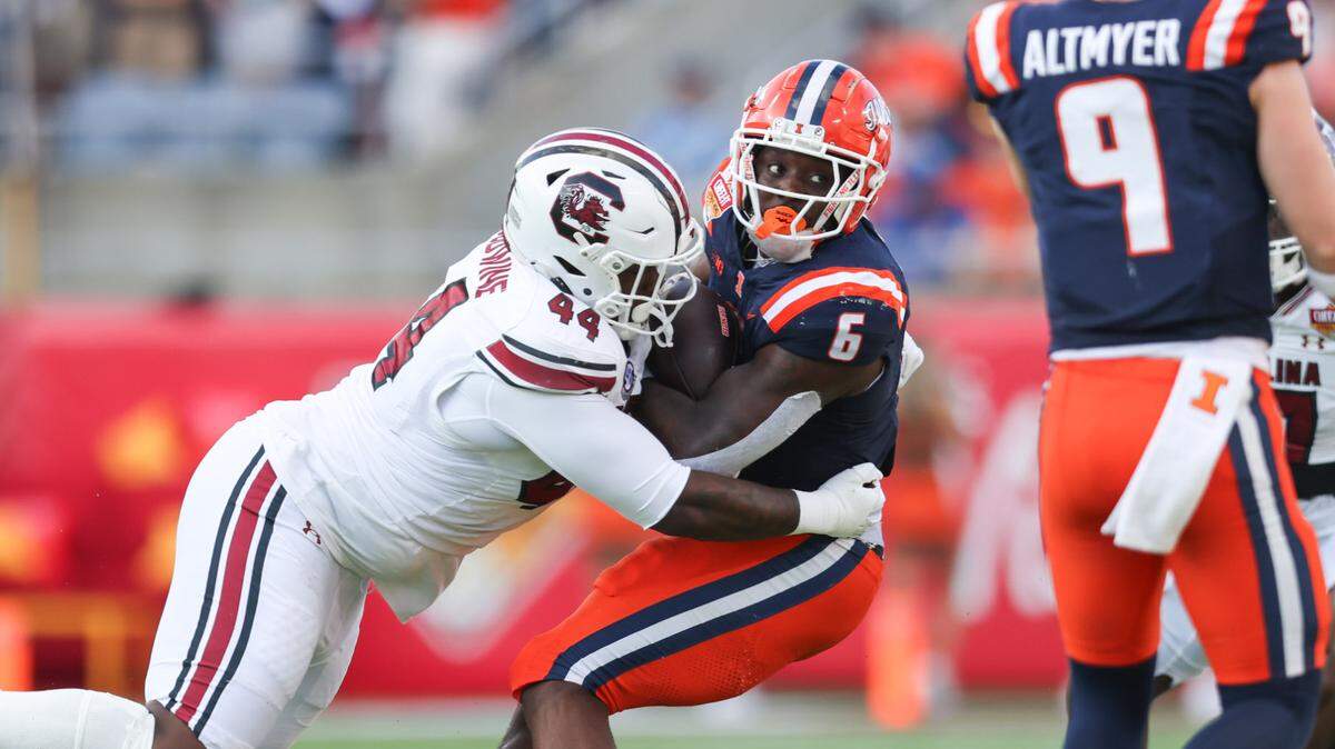 South Carolina defensive tackle Monkell Goodwine (44) wraps up Illinois running back Josh McCray (6) during the first half of the Cheez-It Citrus Bowl at Camping World Stadium in Orlando, Florida on Tuesday, December 31, 2024.


