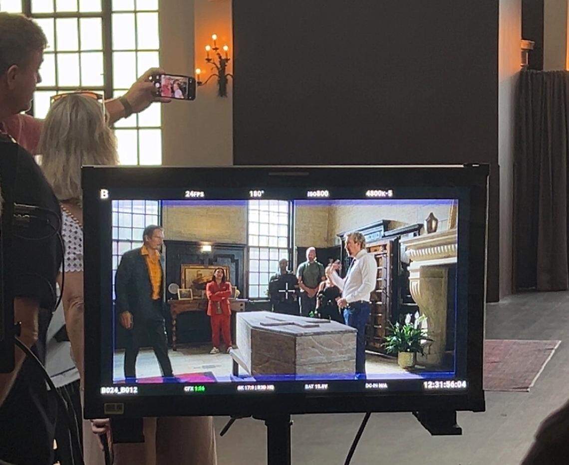 A screen shows footage from a scene rehearsal featuring lead actor David A.R. White, right, in the new action film “Straight Shot”  filmed in downtown Columbia on Aug. 13, 2025.