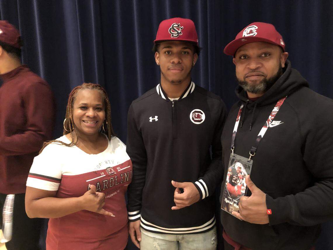 South Carolina running back recruit Rashad Amos (center) with his parents on Signing Day, Dec. 18, 2019.
