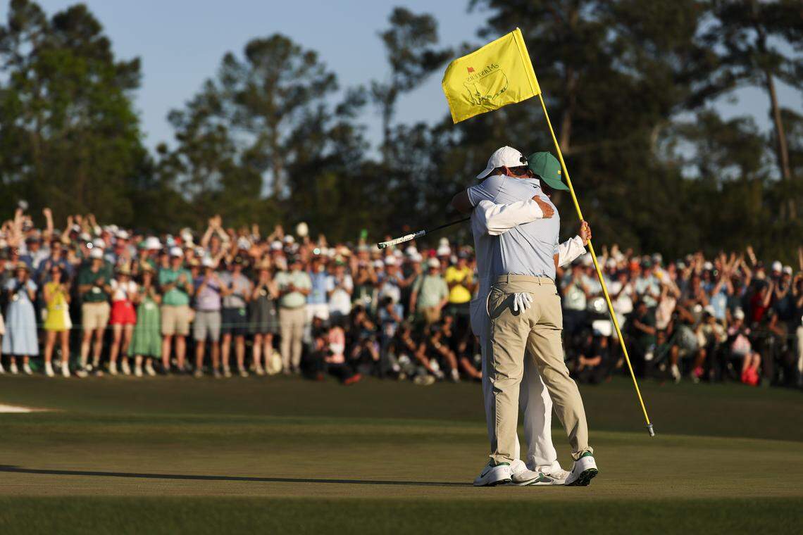 Rory McIlroy of Northern Ireland and his caddie Harry Diamond celebrate winning the 2026 Masters Tournament on the 18th green at Augusta National Golf Club on Sunday in Augusta, Georgia.