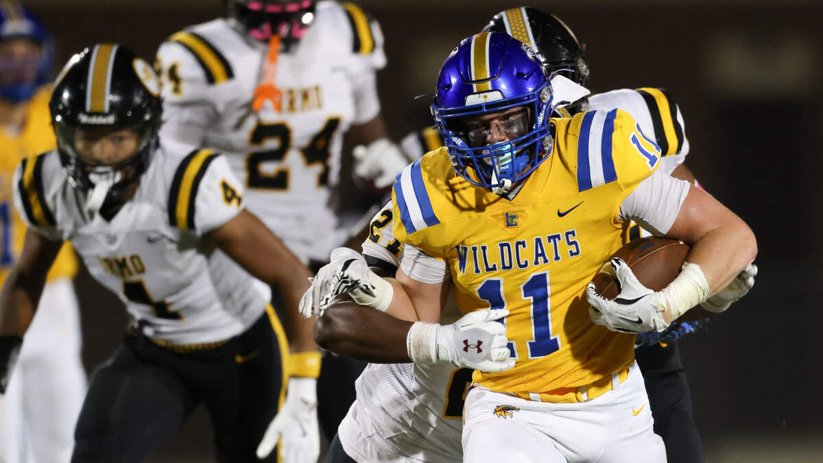 Matt McAulay (11) of Lexington gets wrapped up by Jevonte Hill (27) of Irmo during Lexington’s game against Irmo in Lexington on Friday, October 4, 2024.