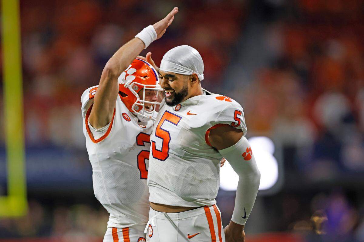 Clemson quarterbacks Cade Klubnik and DJ Uiagalelei celebrate Klubnik’s fourth-quarter touchdown pass in Monday’s win over Georgia Tech.