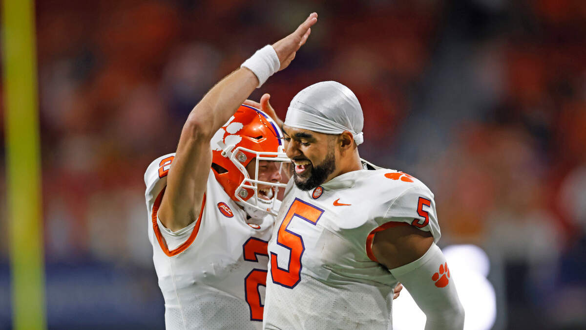 Clemson quarterbacks Cade Klubnik and DJ Uiagalelei celebrate Klubnik’s fourth-quarter touchdown pass in Monday’s win over Georgia Tech.