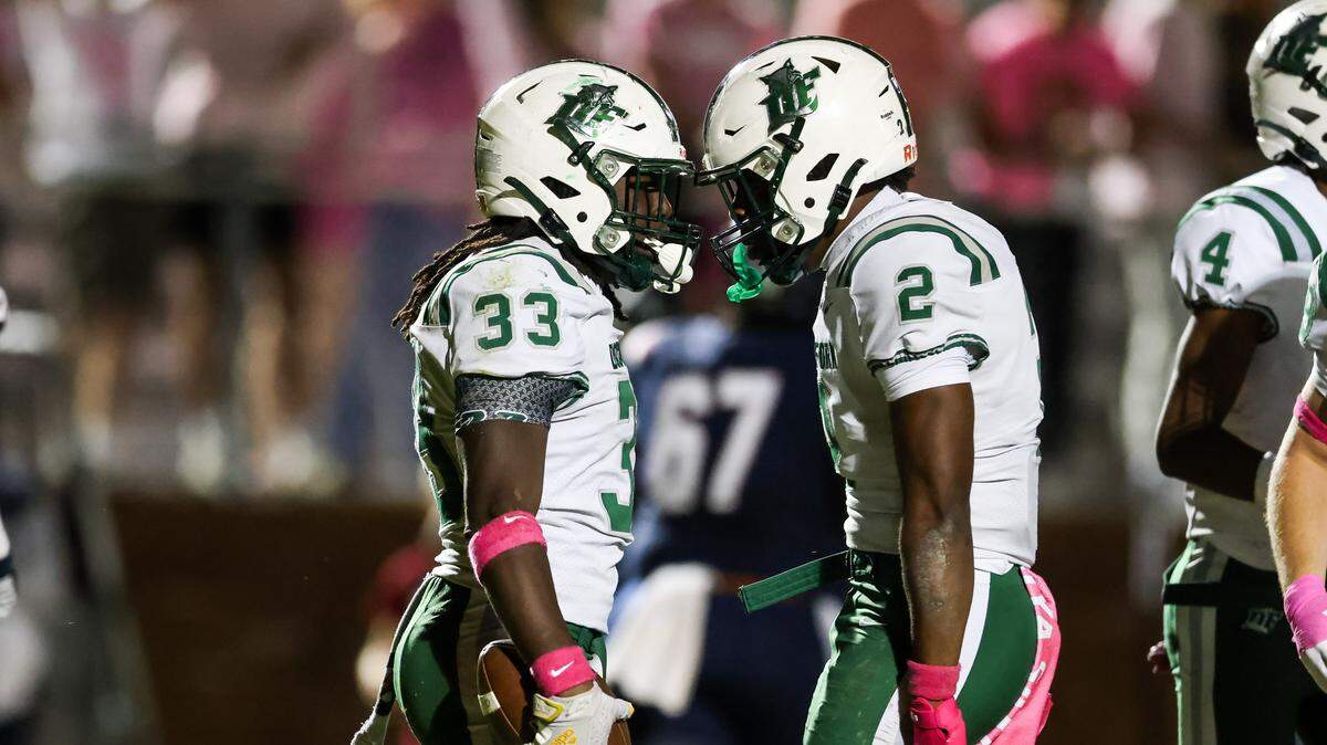 Ethan Moze (33) of Dutch Fork celebrates with Mario Anderson (2) following an interception during White Knoll’s game against visiting Dutch Fork in Lexington on Friday, October 10, 2025.