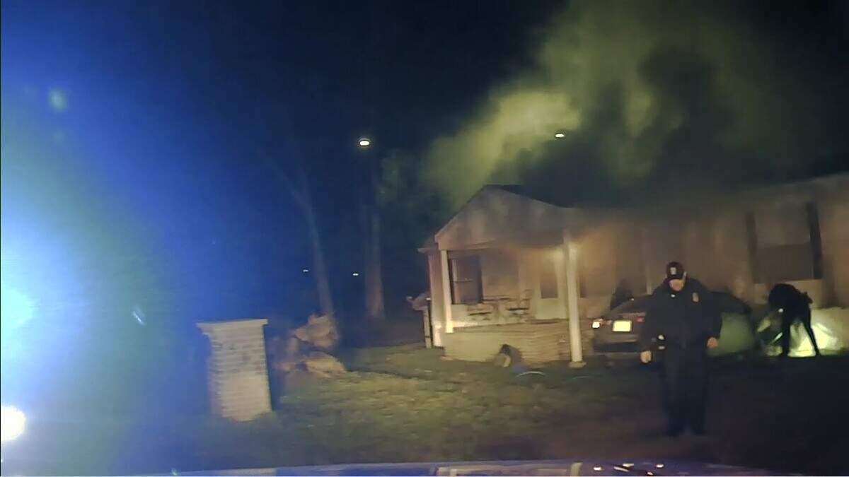 Unable to put out the flame coming from the hood of the crashed car with either a handheld fire extinguishers or a garden hose, law enforcement begins evacuating the scene of the crash on Storm Branch Road before the fire department arrives.