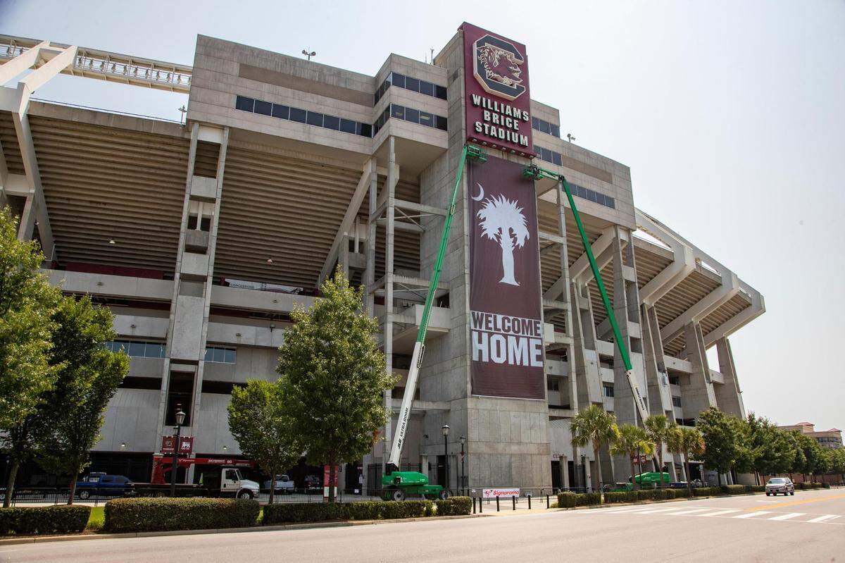 A new banner is placed at Williams-Brice Stadium on Saturday, July 24, 2021. The new banner says “welcome home” and features a palmetto tree and crescent moon in the University of South Carolina’s school colors.