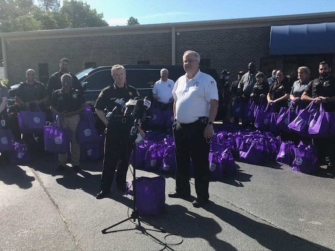 Richland County Sheriff Leon Lott, left, and Coroner Gary Watts speak about senior care relief bags.