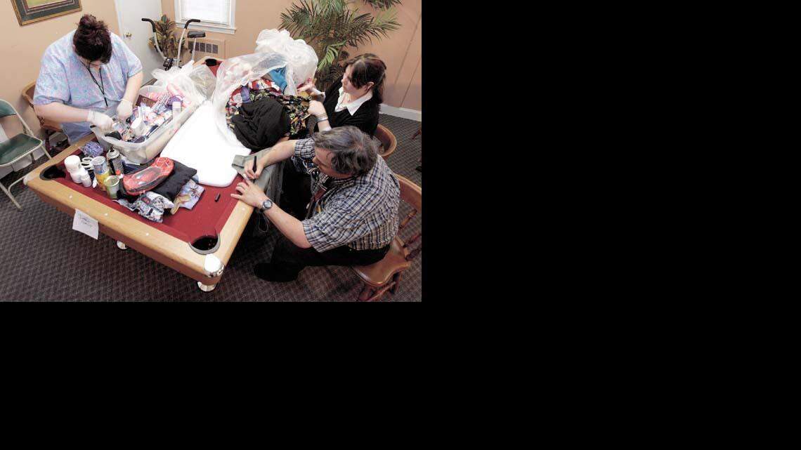 Residential care workers at Sumter's Trinity Place sort through the belongings earlier this year of 17 former residents of Peachtree Manor, a residential care home. After allegations surfaced of life-threatening conditions at Peachtree, residents were transferred from the Winnsboro facility to Trinity Place.