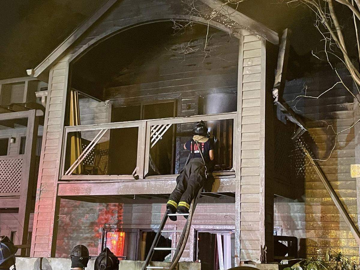 Members of the Columbia Fire Department respond to a burning apartment building.