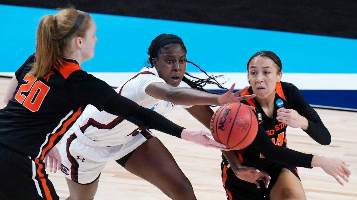 South Carolina forward Laeticia Amihere, center, tries to steal the ball from Oregon State forward Ellie Mack (20) and guard Savannah Samuel, right, during the first half of a college basketball game in the second round of the women’s NCAA tournament at the Alamodome in San Antonio, Tuesday, March 23, 2021.