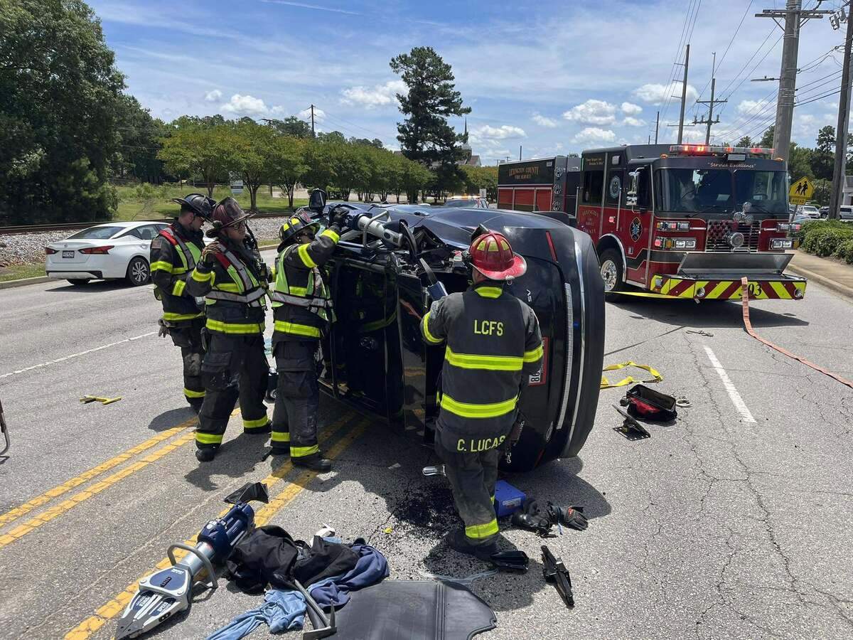 Members of the Lexington County Fire Service respond to an overturned car following a crash.