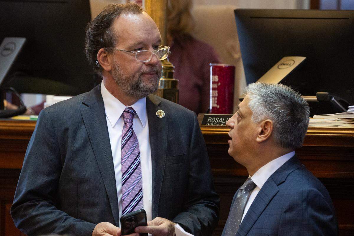 South Carolina State Representative Ways and Means Chairman Bruce Bannister, R-Greenville, and State Representative Rep. Leon Stavrinakis, D-Charleston, speak as house members debate amendments to the state budget on Tuesday, March 11, 2025.