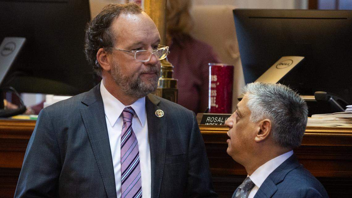 South Carolina State Representative Ways and Means Chairman Bruce Bannister, R-Greenville, and State Representative Rep. Leon Stavrinakis, D-Charleston, speak as house members debate amendments to the state budget on Tuesday, March 11, 2025.