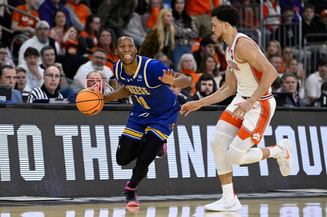 Mar 20, 2025; Providence, RI, USA; McNeese State Cowboys guard Quadir Copeland (11) brings the ball up court against Clemson Tigers guard Chase Hunter (1) during the second half at Amica Mutual Pavilion.