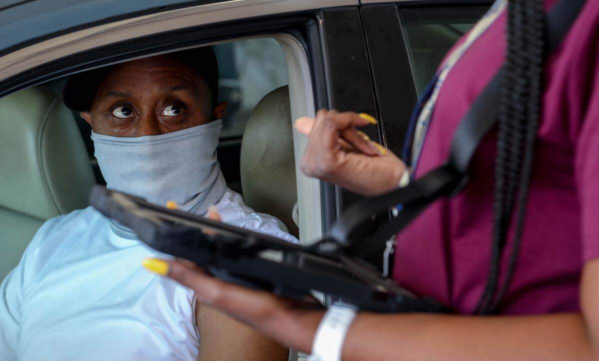 Vernon Singleton is processed before receiving a coronavirus vaccination during the first day at a mass-vaccination site set up by FEMA at the Columbia Place Mall in Columbia. The site will be able to vaccinate about 1,000 people a day.