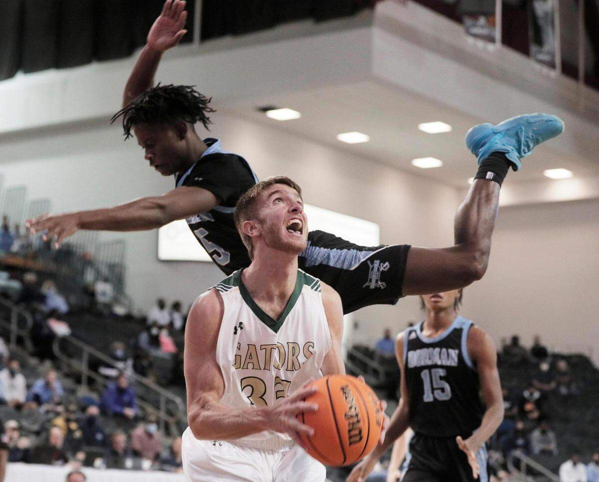 River Bluff’s Malachi Reeves 33 shoots as Dorman’s Davison Wright 5 sails by in Aiken, South Carolina on Saturday, March 6, 2021.