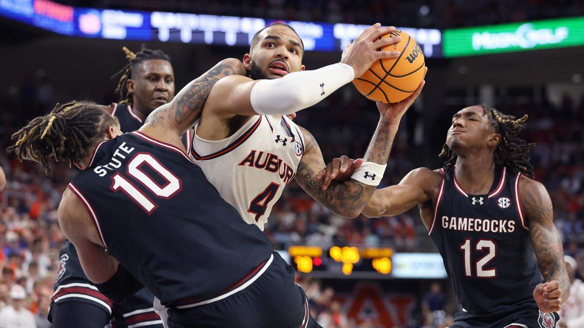 South Carolina Gamecocks guard Myles Stute (10) and guard Zachary Davis (12) Auburn Tigers forward Johni Broome (4) during the second half at Neville Arena.