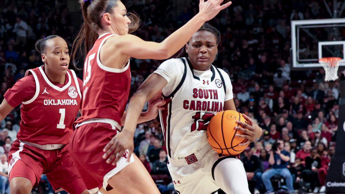 University of South Carolina’s MiLaysia Fulwiley (12) drives by Oklahoma’s Lexy Keys (15) during the first half of action in the Colonial Life Arena on Sunday, Jan. 19, 2025.
