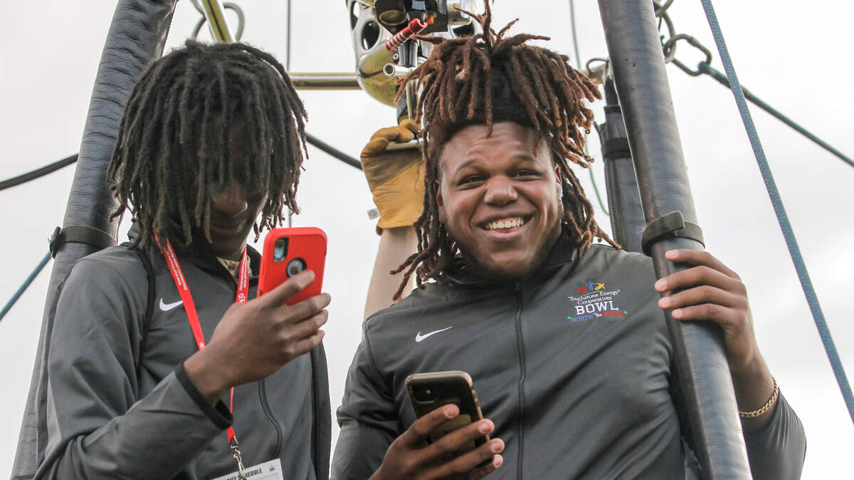 South all star D.J. Watson, right, takes in a hot air balloon ride with a teammate at Doug Shaw Memorial Stadium in Myrtle Beach, S.C. on Friday, Dec. 10, 2021. The event was part of the Touchstone Energy Bowl activities leading up to the game. (Travis Bell/SIDELINE CAROLINA)