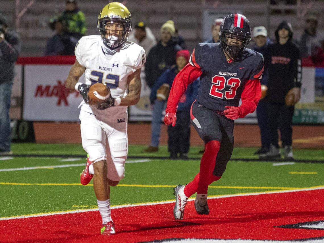 Bishop McDevitt’s Tyshawn Russell scores a second-quarter touchdown with Aliquippa’s Tiqwai Hayes defending during the PIAA Class 4A football state championship game in Mechanicsburg, Pa., Thursday, Dec. 8, 2022. (Mark Pynes/The Patriot-News via AP)
