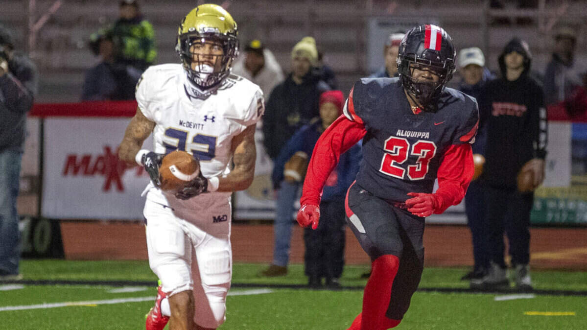 Bishop McDevitt’s Tyshawn Russell scores a second-quarter touchdown with Aliquippa’s Tiqwai Hayes defending during the PIAA Class 4A football state championship game in Mechanicsburg, Pa., Thursday, Dec. 8, 2022. (Mark Pynes/The Patriot-News via AP)