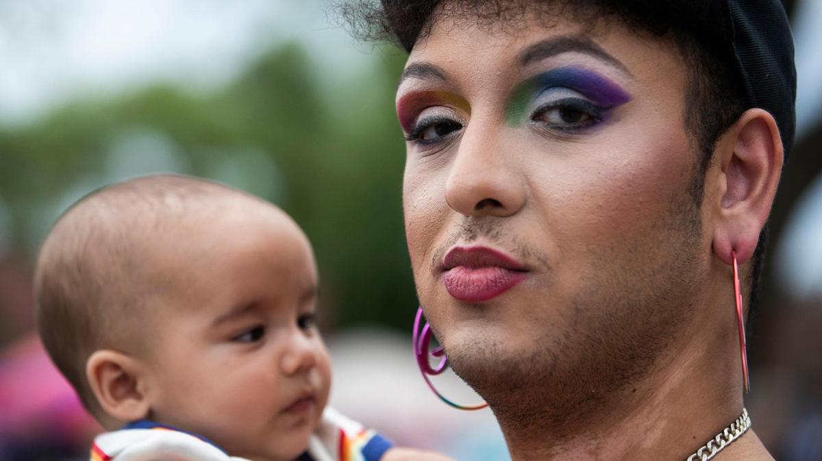 Mo Isfail holds Oliver Perry, a four-month-old baby, at OutFest in Columbia, South Carolina on Saturday, June 6, 2021. Isfail is neighbor’s with Perry’s parents, and ran into multiple friends and neighbors at the festival.