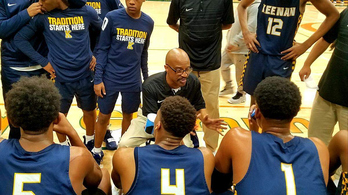 Keenan coach Zach Norris talks to his team during a timeout of Monday’s matchup with Gray Collegiate at Crescent Construction MLK Bash at Eau Claire High School.