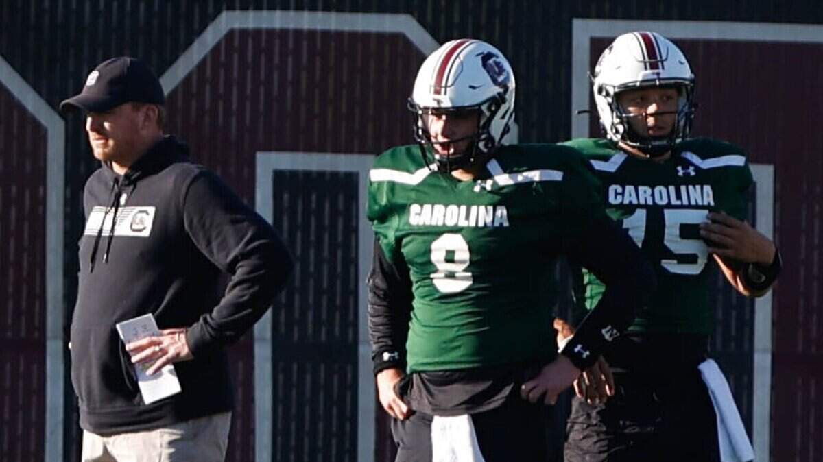 South Carolina’s quarterbacks coach Marcus Satterfield, quarterback Zeb Noland (8) and quarterback Jason Brown (15) watch a drill during practice on Monday, Dec. 13, 2021. The Gamecocks are preparing for the Dukes Mayo Bowl at the Bank of America Stadium in Charlotte.