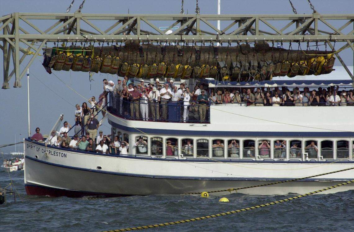 8/8/2000 - Passengers aboard the Spirit of Charleston get a special close-up view of the H.L. Hunley after it was raised out of the water near Sullivan’t Island on Tuesday. Jason Clark/The State