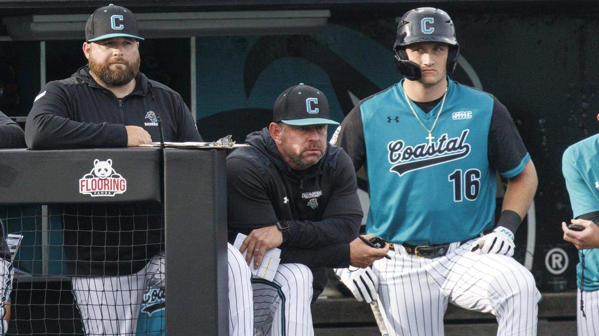 Coastal Carolina University head baseball coach Kevin Schnall, center