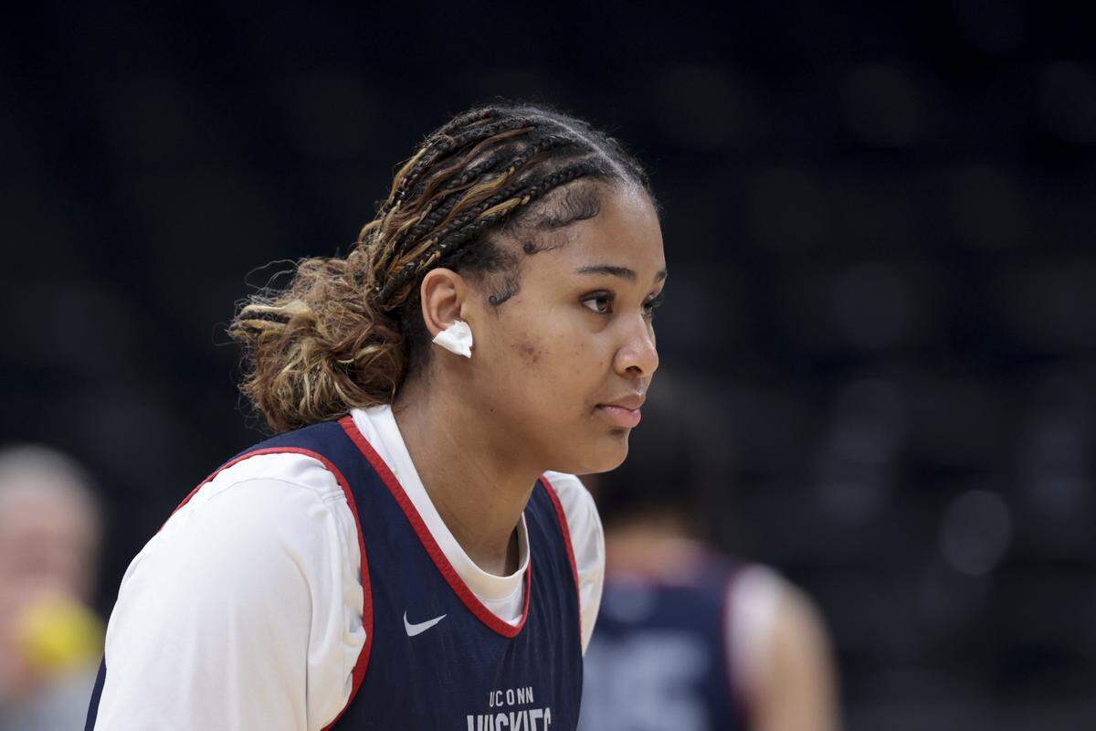 University of Connecticut’s Sarah Strong (21) stretches with the team during practice for their Final Four game against the University of South Carolina at Mortgage Matchup Center in Phoenix on Thursday, April 2, 2026.