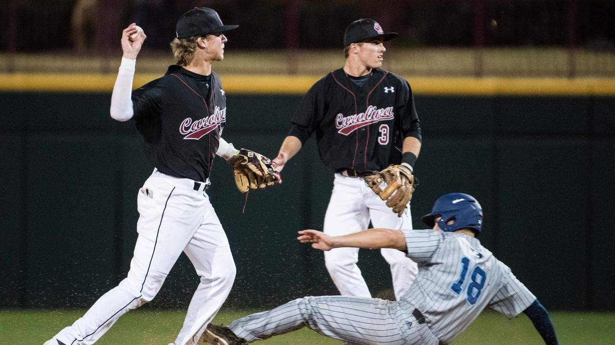 South Carolina shortstop LT Tolbert, left, and Justin Row (3) turn a game ending double play against the Citadel's William Kinney (18) during Tuesday night's game at Founders Park on March 7, 2017 in Columbia, S.C. South Carolina defeated the Citadel 12-5. 3/7/17