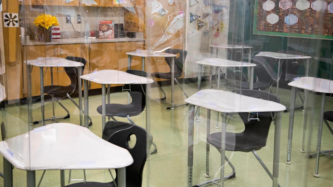 Kayla Hostetler classroom is armed with plastic dividers at Aiken High School on Tuesday, March 23, 2021. Lawmakers are considering forcing school districts to offer in-person instruction five days a week starting April 26.