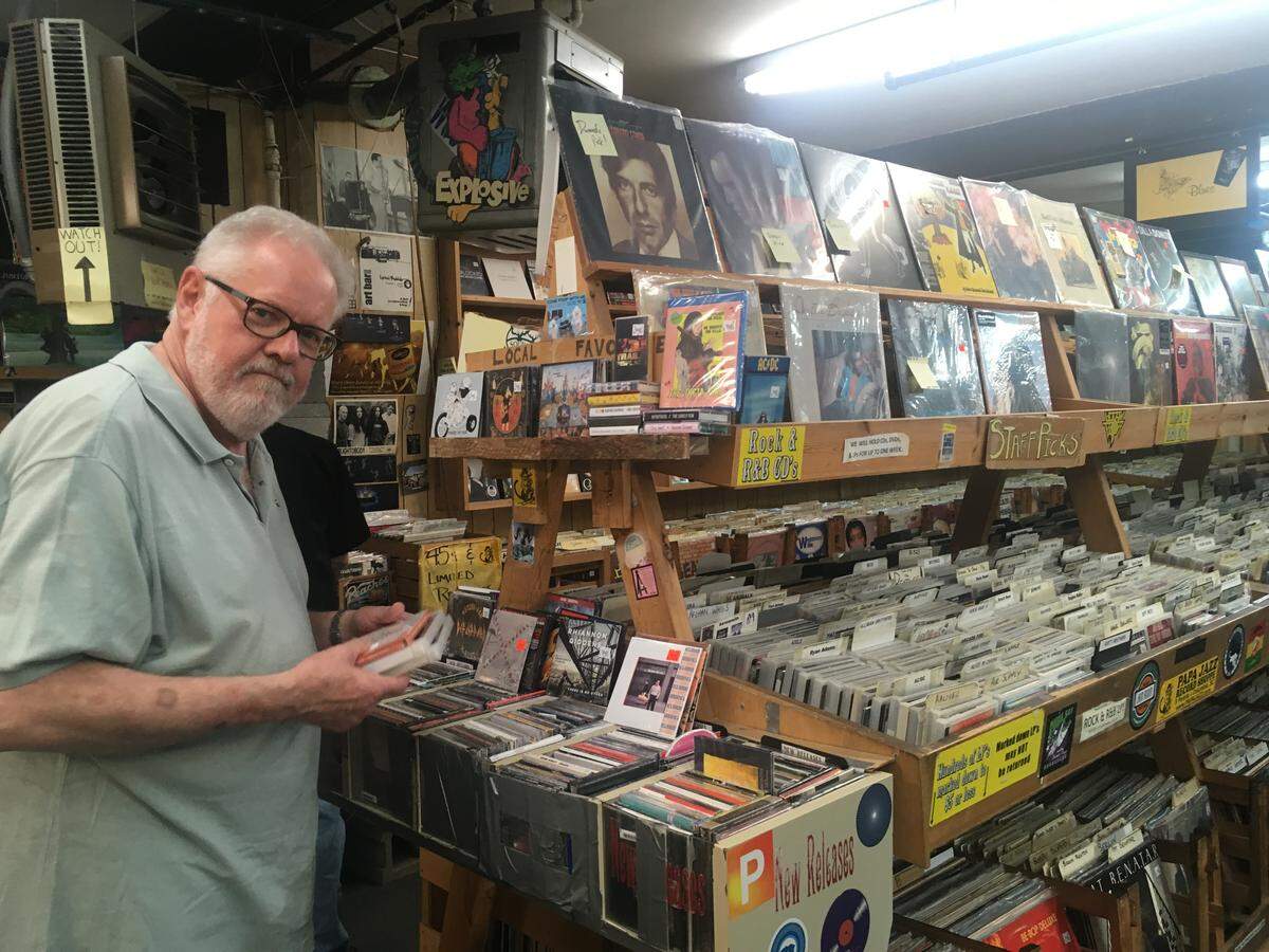 Allen Roberson looks through the new release sections at Papa Jazz