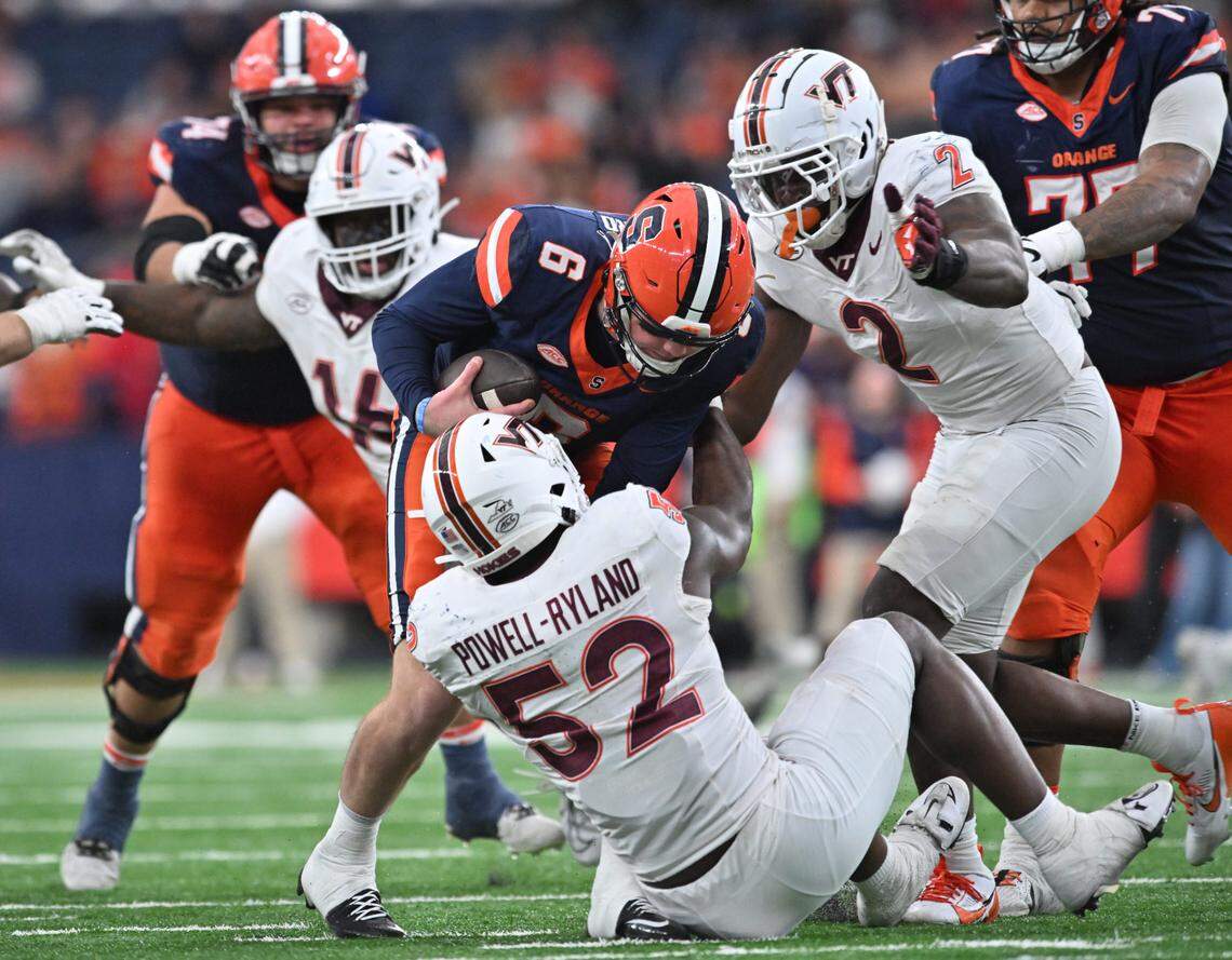 Nov 2, 2024; Syracuse, New York, USA; Virginia Tech Hokies defensive lineman Antwaun Powell-Ryland (52) sacks Syracuse Orange quarterback Kyle McCord (6) in the fourth quarter at JMA Wireless Dome.