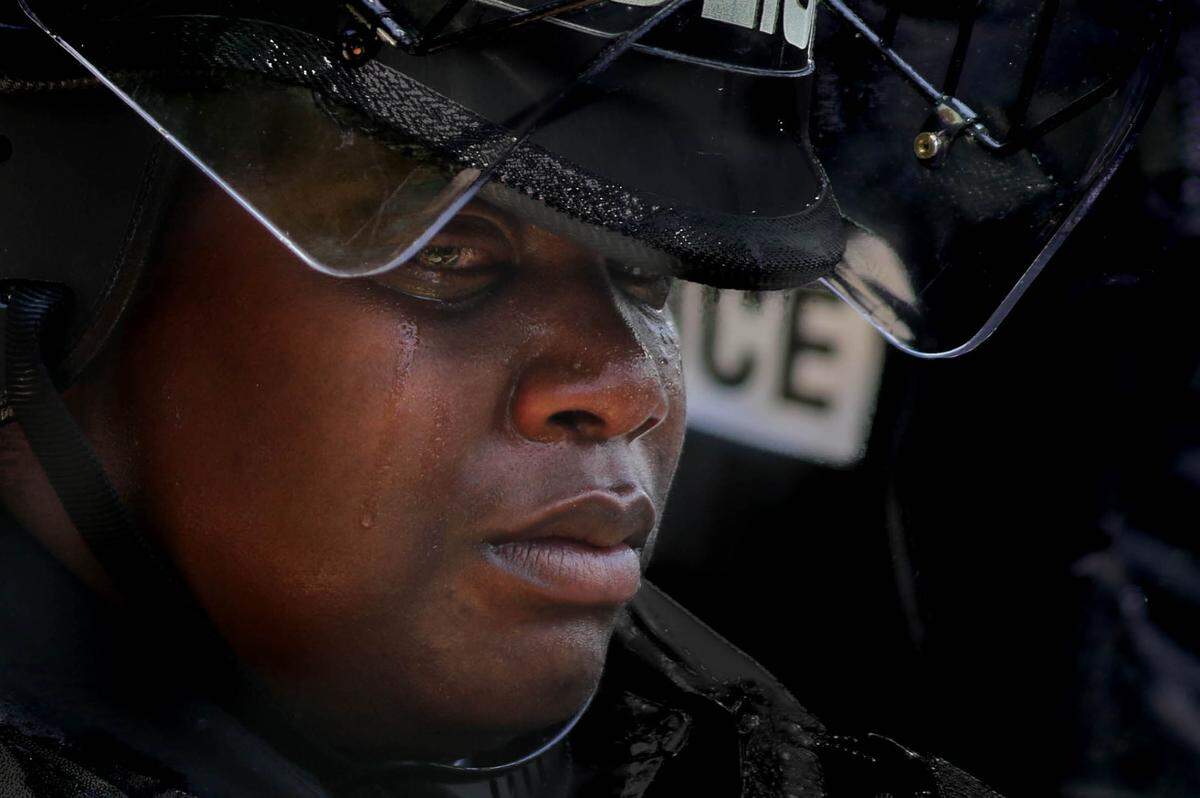 A tear rolls down the face of a Columbia Police officer as protestors rally in front of the Columbia Police Department.
