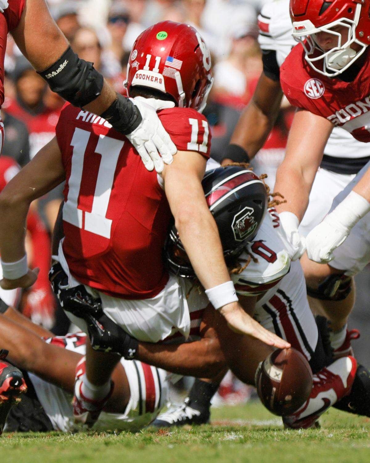 Oklahoma’a Jackson Arnold (11) fumbles the ball as he is hit by South Carolina’s Debo Williams (0) in the first quarter, Saturday, Oct. 19, 2024, at Gaylord Family - Oklahoma Memorial Stadium in Norman, Okla. OU recovered the fumble.