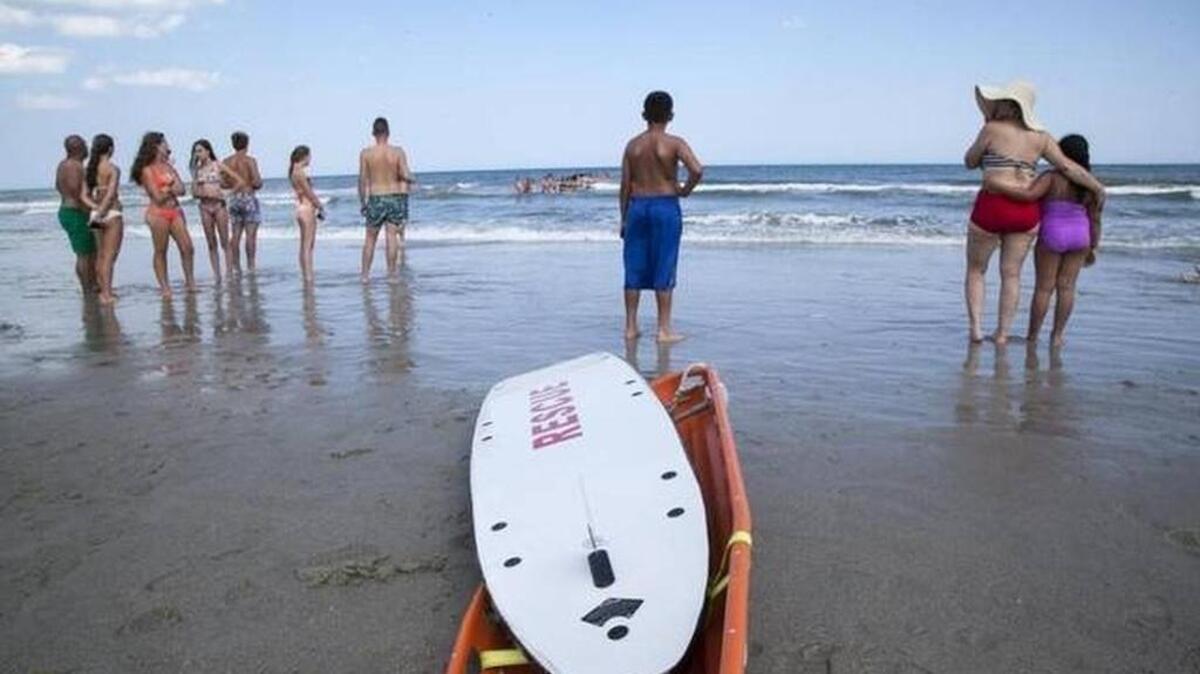 Rescuers gathered Wednesday in response to three distressed swimmers. One swimmer was pronounced dead Friday, and his brother is still missing.