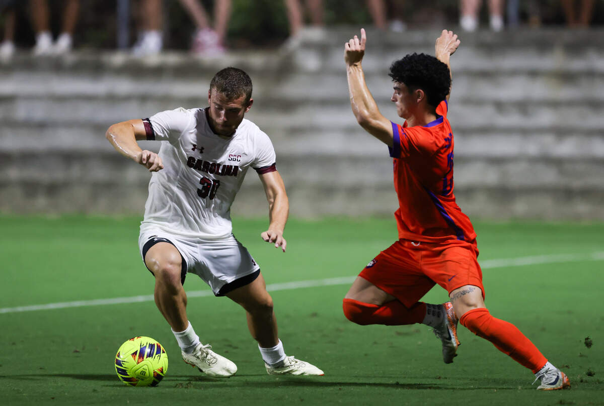 South Carolina forward Gabe Nickerson (30) is defended Clemson midfielder Nathan Richmond (25) during the Gamecocks’ game against Tigers in Columbia on Friday, August 30, 2024.