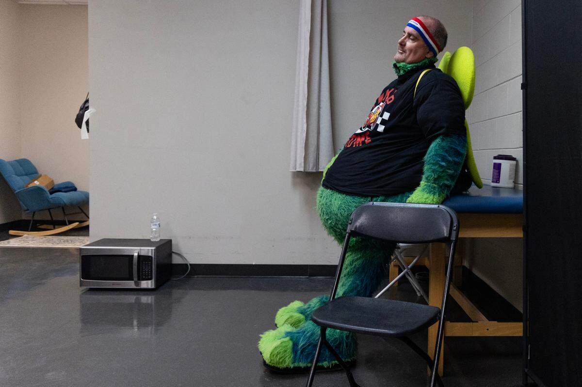 The State reporter Chris Trainor rests in the Fireflies mascot costume at Segra Park as the Fireflies play the Pelicans on Thursday, April 11, 2024.