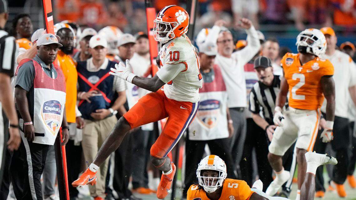 Clemson wide receiver Joseph Ngata (10) runs for a first down past Tennessee defensive back Kamal Hadden (5) during the first half of the Orange Bowl NCAA college football game Friday, Dec. 30, 2022, in Miami Gardens, Fla. (AP Photo/Lynne Sladky)