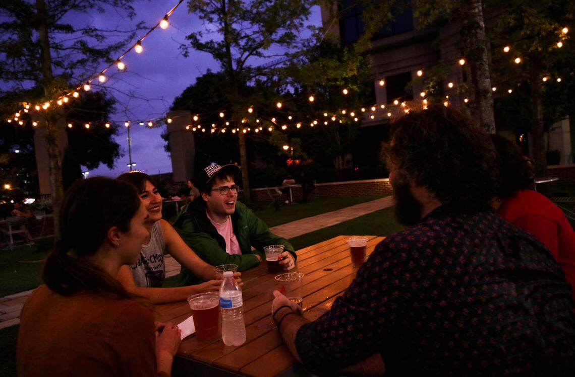 Carolyn Culbertson, from left, Haley Kellner, Chris Blaikie , Nathan Gates and Andrew Crossan enjoy First Thursday on Main at Columbia’s Boyd Plaza.