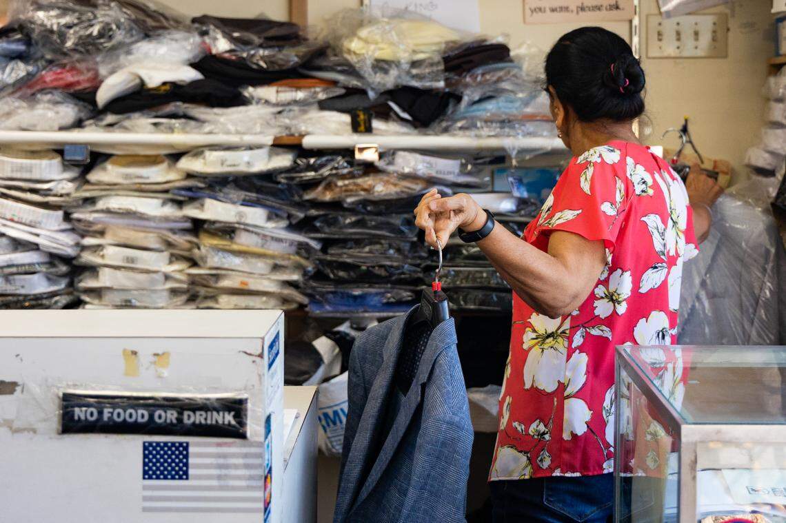 Jaya Tolani, owner of Looking Good on Two Notch Road, picks out a suit for The State photojournalist Joshua Boucher on Thursday, September 4, 2025.