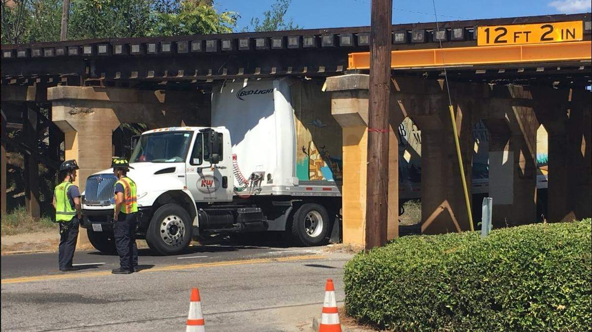 A Bud Light truck gets stuck while passing under train tracks on Whaley Street in Columbia.
